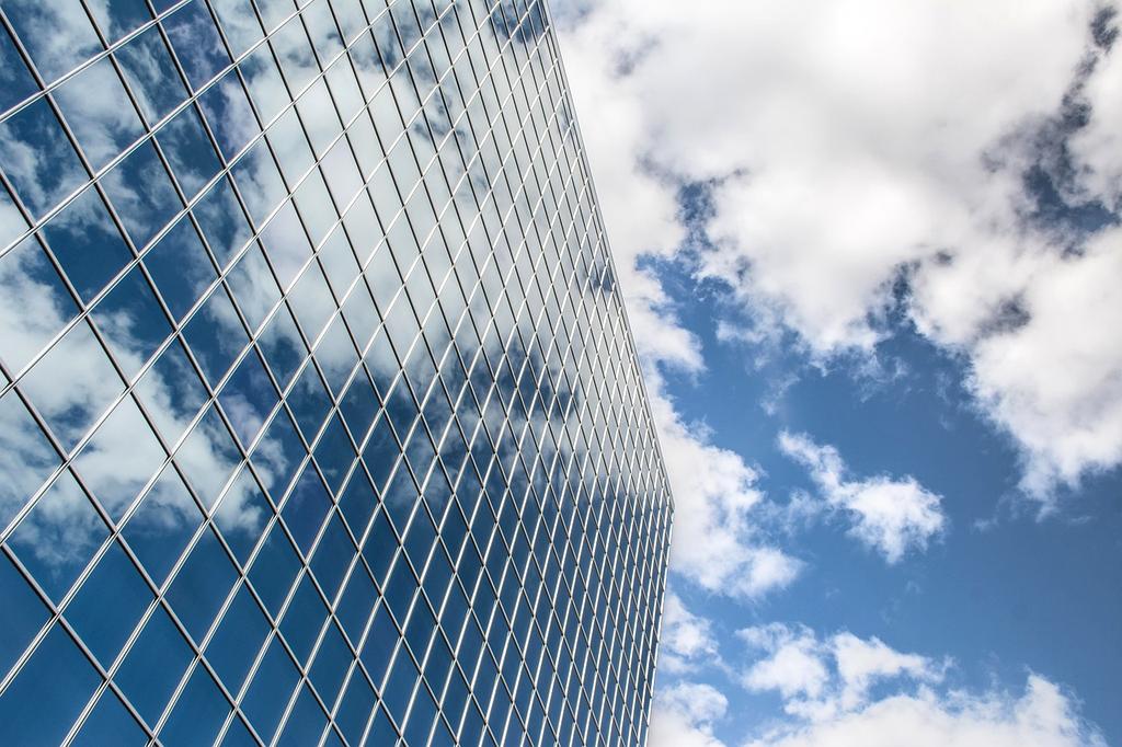 Cleaner washing large glass office windows